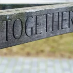 The back rest of a bench with engraved "Together"
