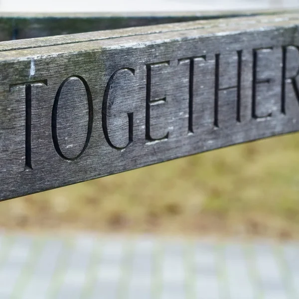 The back rest of a bench with engraved "Together"