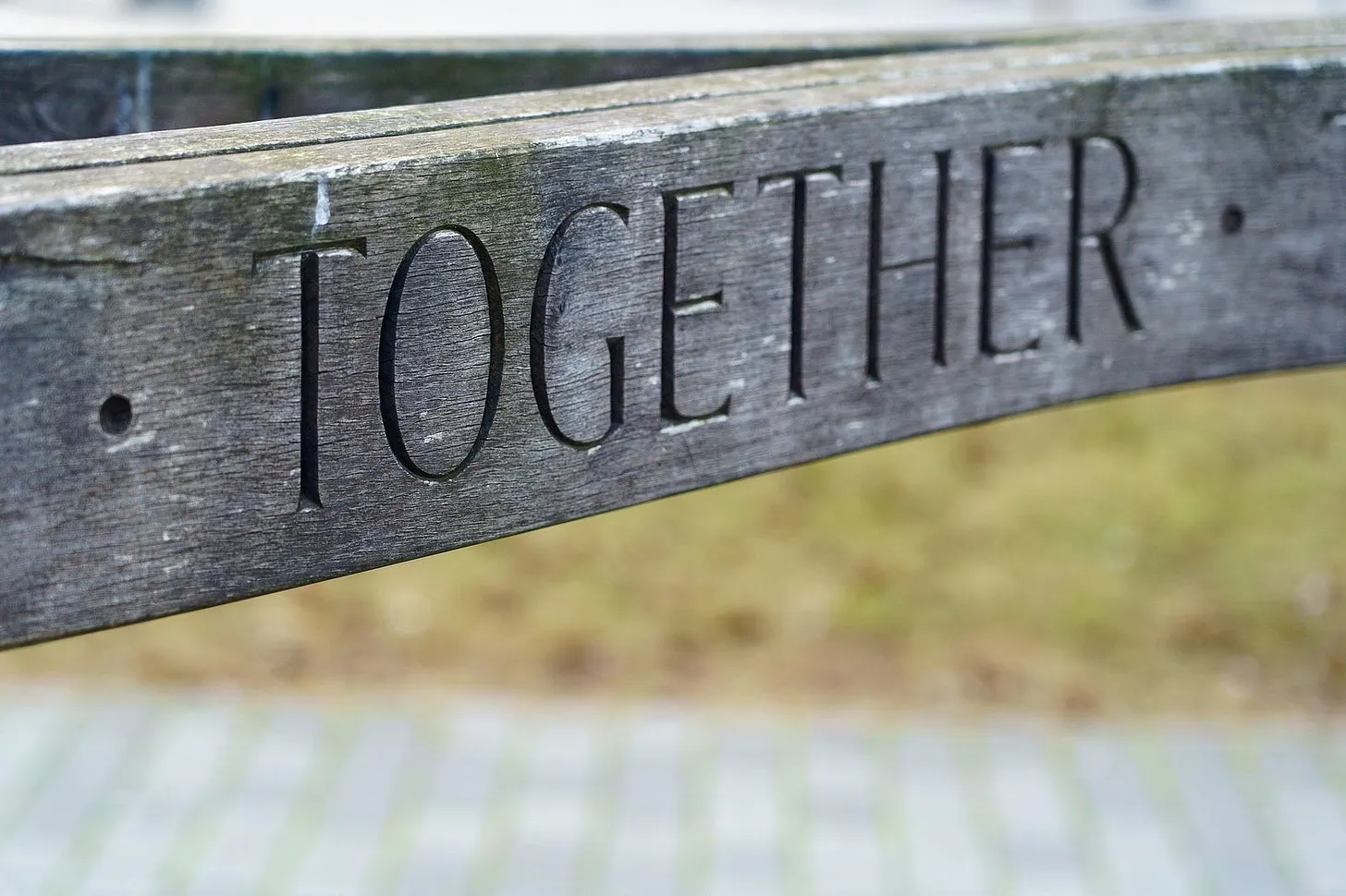 The back rest of a bench with engraved "Together"