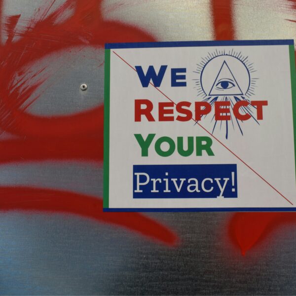 A sign hanging on a wall with the text "We respect your privacy"