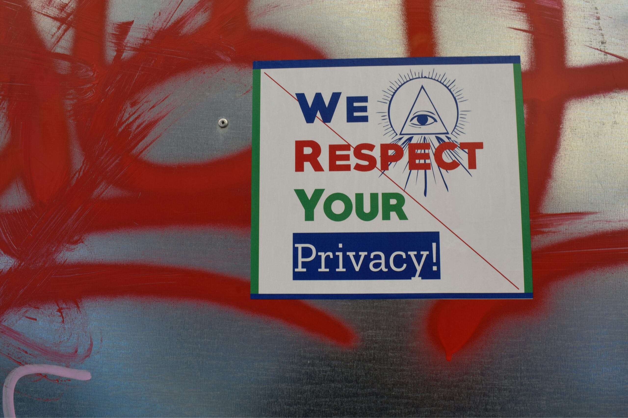 A sign hanging on a wall with the text "We respect your privacy"