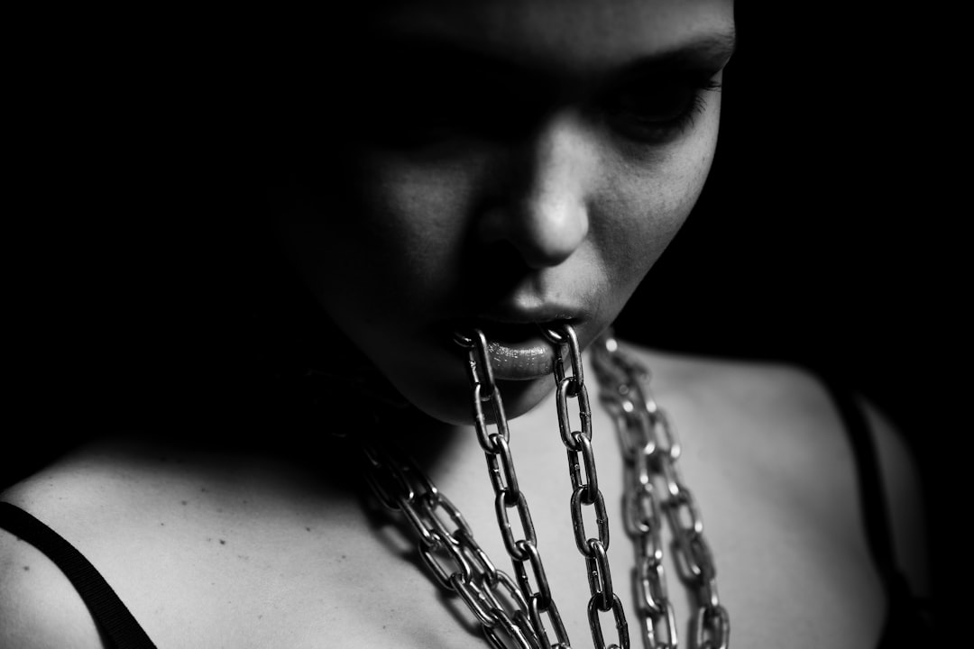 Woman holding chains with her mouth